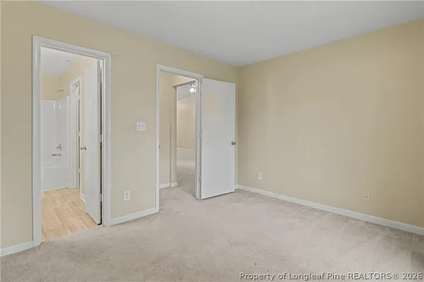 a view of an empty room and closet area