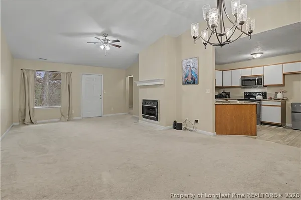 a view of a kitchen with a sink and stainless steel appliances