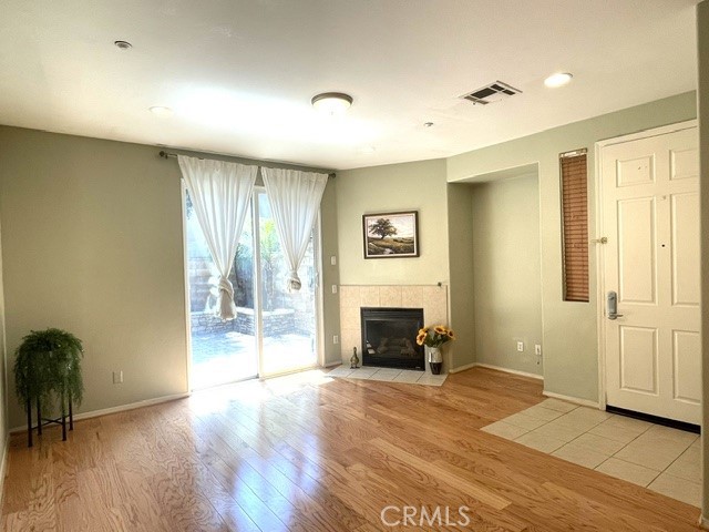 8692 East 9th Street, Unit 56 Rancho Cucamonga, CA 91730 - Photo 7 of 34 a view of an empty room with a fireplace and a window