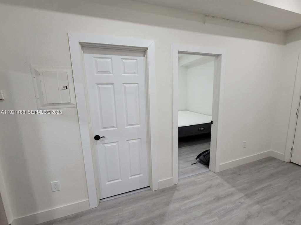 734 Southwest 4th Street, Unit 8 Miami, FL 33130 - Photo 2 of 5 wooden floor and closet in a room