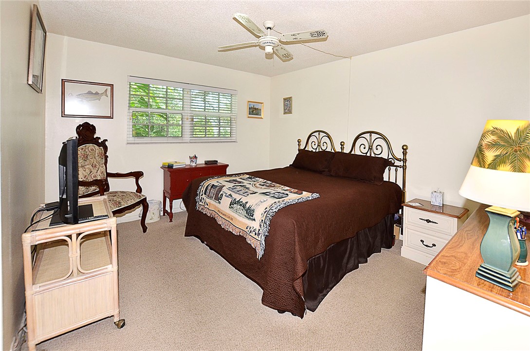 900 Jasmine Lane, Unit 9A Vero Beach, FL 32963 - Photo 13 of 26 a bedroom with a bed next to a window with the outer view