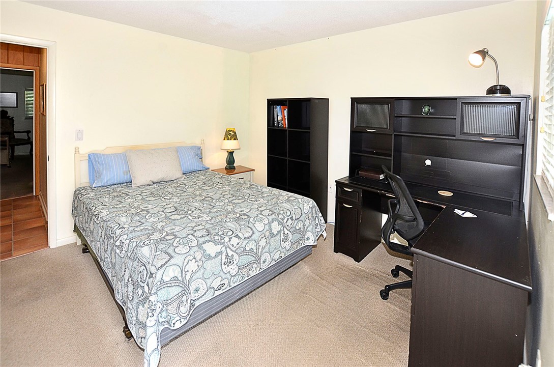 900 Jasmine Lane, Unit 9A Vero Beach, FL 32963 - Photo 16 of 26 a bedroom with a bed and a dresser