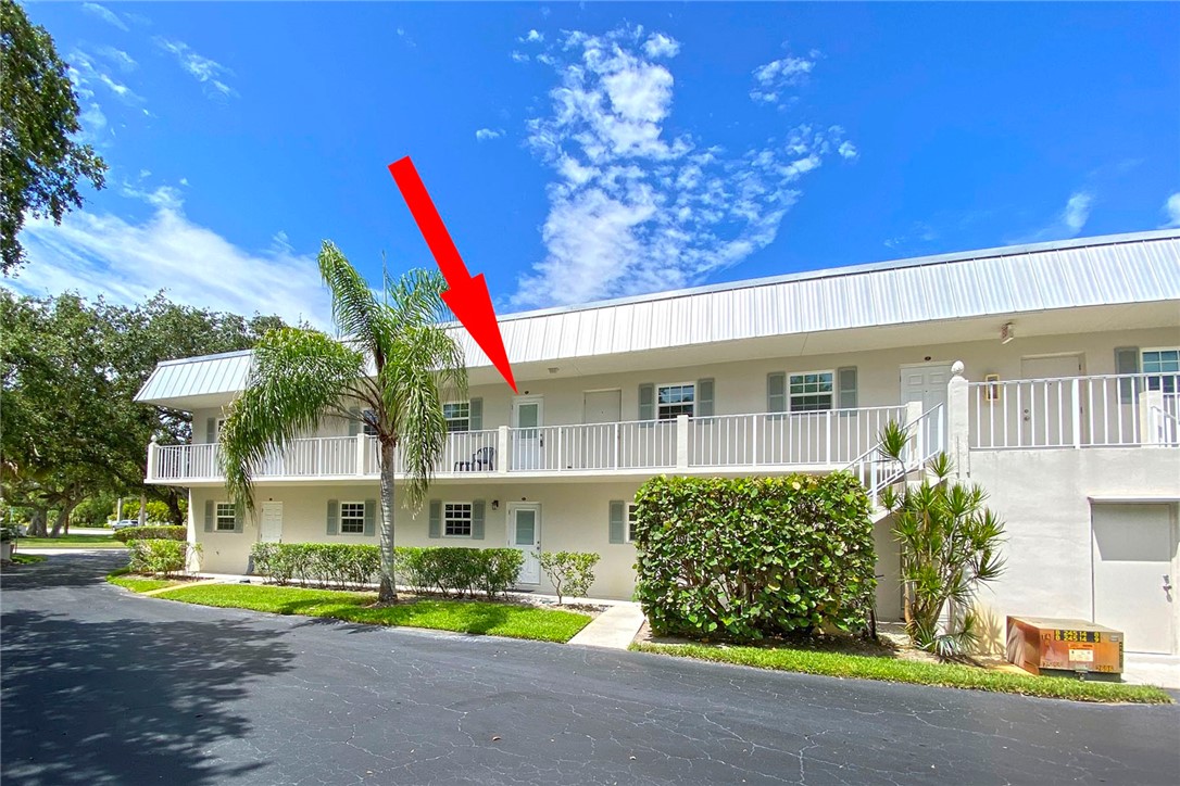 900 Jasmine Lane, Unit 9A Vero Beach, FL 32963 - Photo 2 of 26 a front view of a house with a yard and potted plants