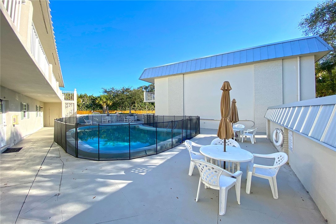 900 Jasmine Lane, Unit 9A Vero Beach, FL 32963 - Photo 21 of 26 a view of a dining room with furniture and wooden floor