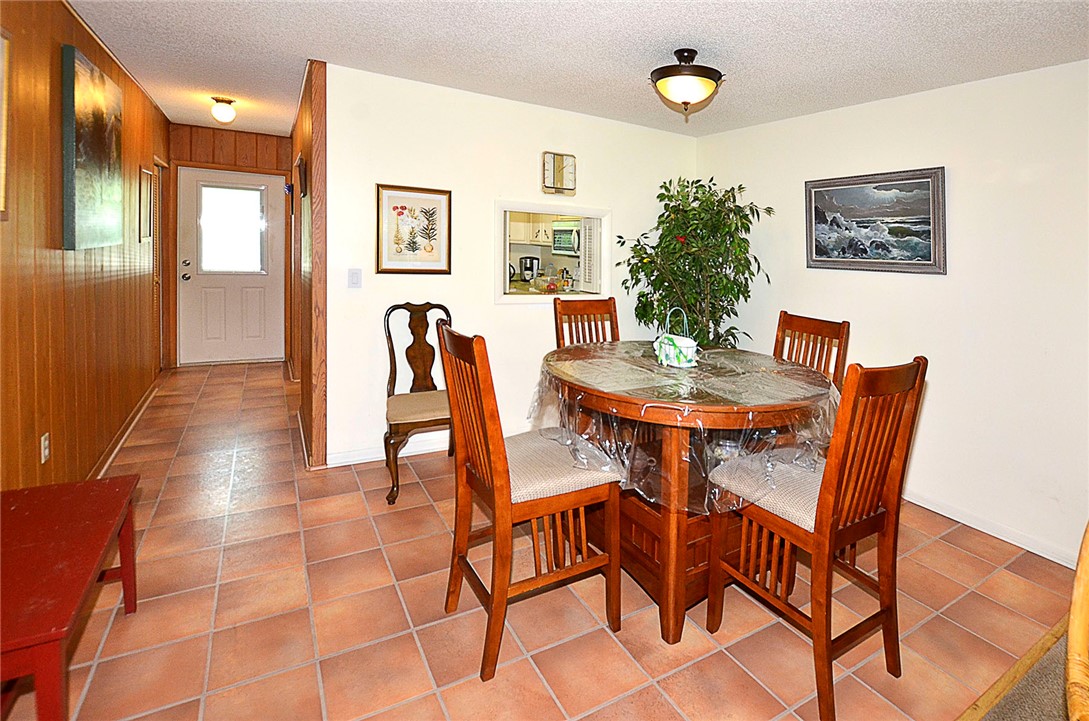 900 Jasmine Lane, Unit 9A Vero Beach, FL 32963 - Photo 3 of 26 a view of a dining room with furniture and wooden floor