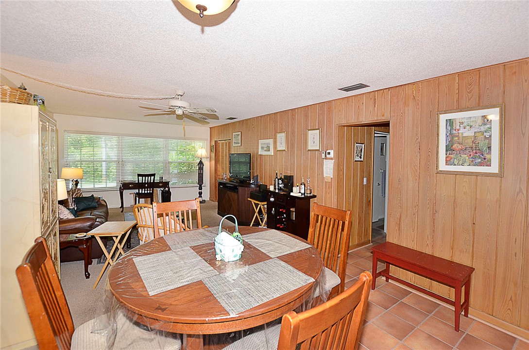 900 Jasmine Lane, Unit 9A Vero Beach, FL 32963 - Photo 5 of 26 a dining room with wooden floor a table and chairs