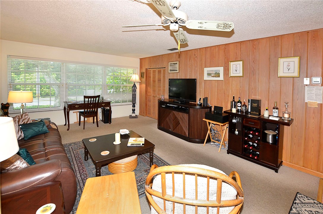 900 Jasmine Lane, Unit 9A Vero Beach, FL 32963 - Photo 6 of 26 a living room with furniture and a flat screen tv