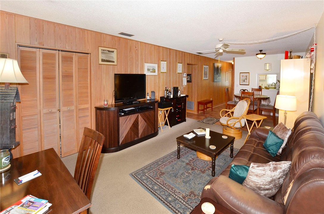900 Jasmine Lane, Unit 9A Vero Beach, FL 32963 - Photo 7 of 26 a living room with furniture and a flat screen tv