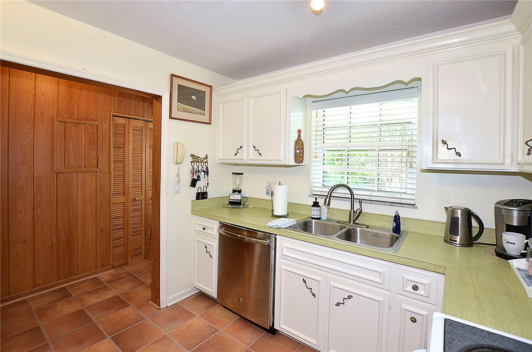 900 Jasmine Lane, Unit 9A Vero Beach, FL 32963 - Photo 9 of 26 a kitchen with stainless steel appliances a sink a stove a refrigerator and cabinets
