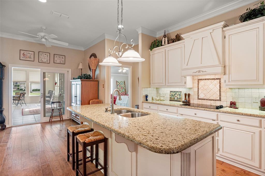 8913 Brierfield Road Granbury, TX 76049 - Photo 12 of 40 a kitchen with center island table and chairs