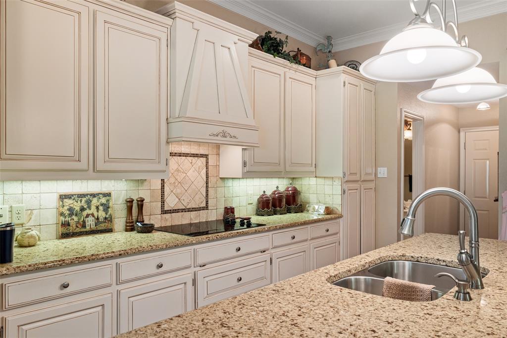 8913 Brierfield Road Granbury, TX 76049 - Photo 13 of 40 a kitchen with white cabinets and sink