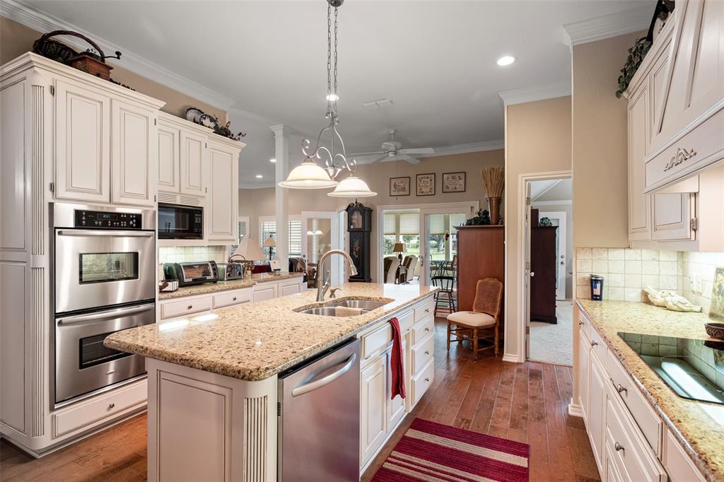 8913 Brierfield Road Granbury, TX 76049 - Photo 14 of 40 a kitchen with stainless steel appliances granite countertop a sink stove and refrigerator