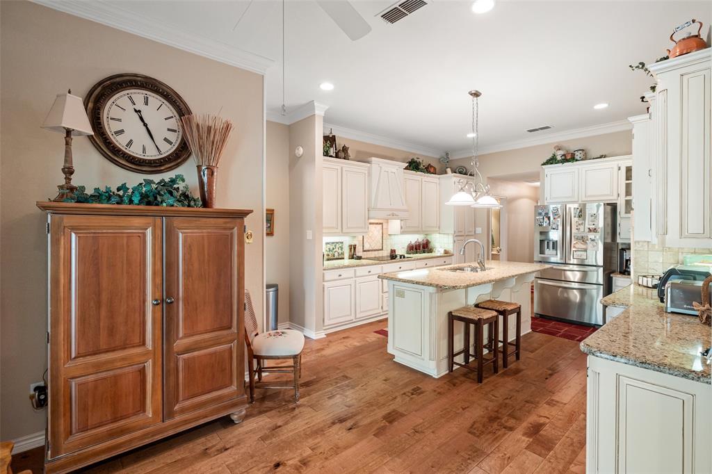 8913 Brierfield Road Granbury, TX 76049 - Photo 15 of 40 a kitchen with stainless steel appliances granite countertop a refrigerator a stove a sink and a dining table with the view living room