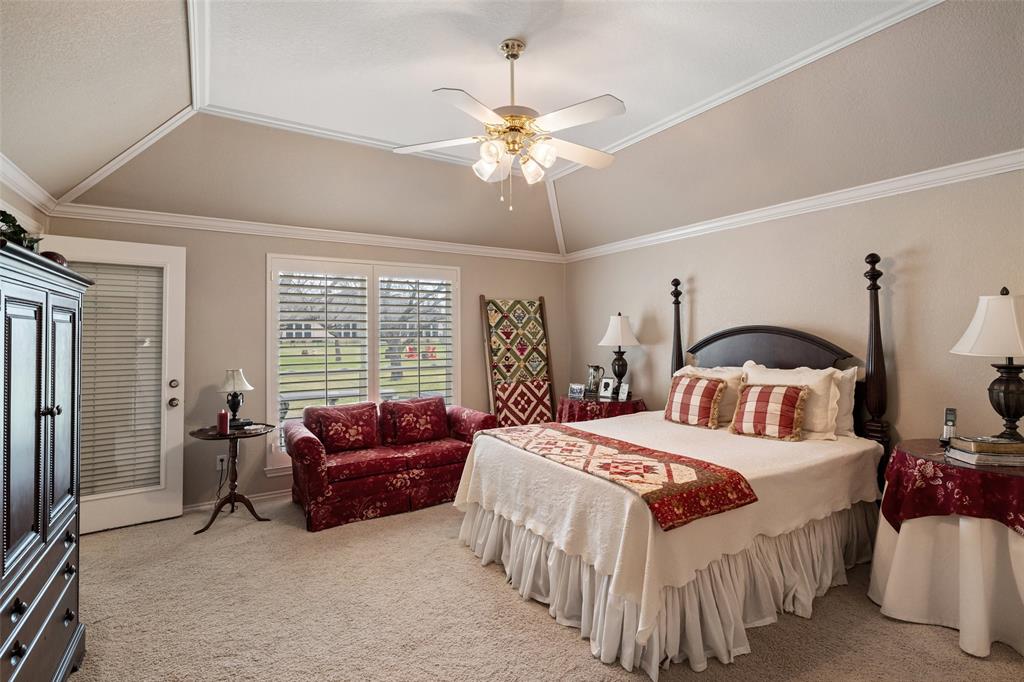 8913 Brierfield Road Granbury, TX 76049 - Photo 21 of 40 a bedroom with a bed and a chandelier