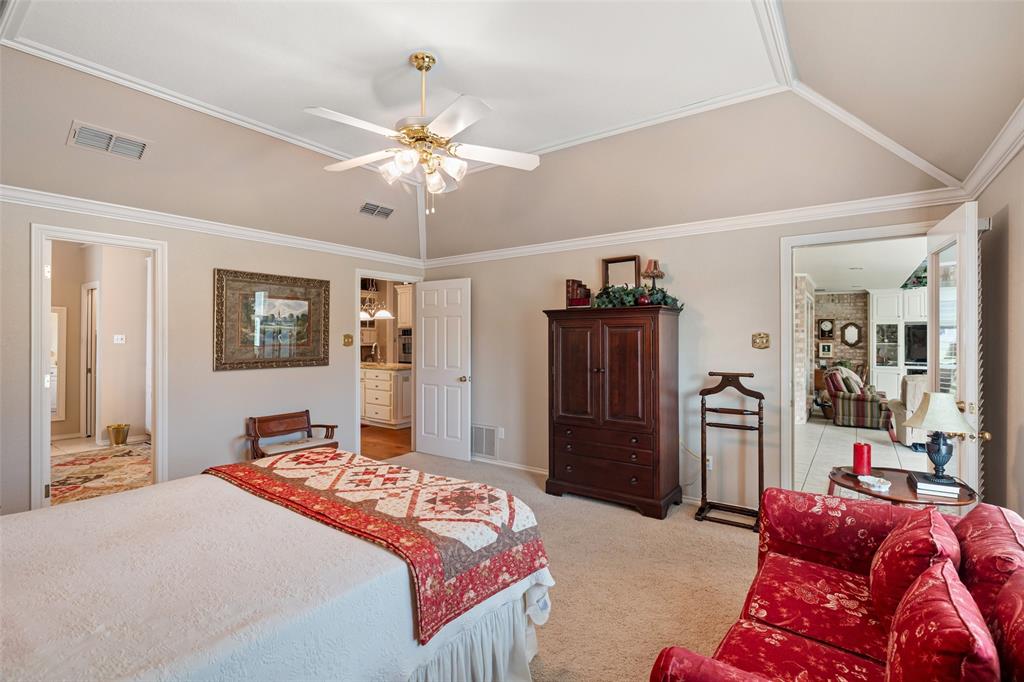 8913 Brierfield Road Granbury, TX 76049 - Photo 22 of 40 a bedroom with a bed and a chandelier
