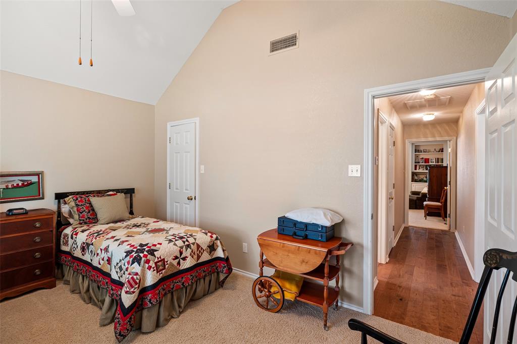 8913 Brierfield Road Granbury, TX 76049 - Photo 27 of 40 a bedroom with a bed and a lounge chair