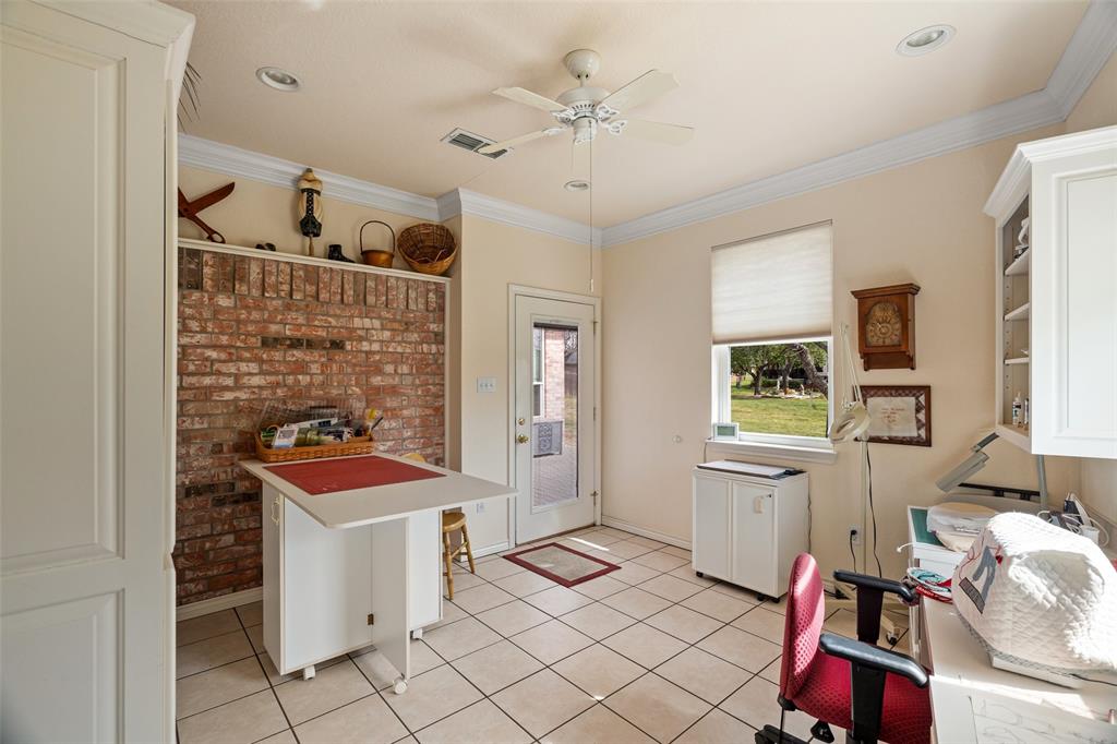 8913 Brierfield Road Granbury, TX 76049 - Photo 34 of 40 a room with furniture a rug and a fan