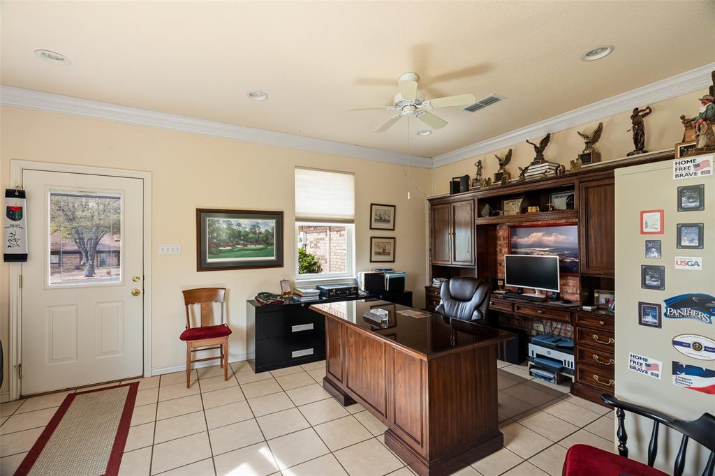 8913 Brierfield Road Granbury, TX 76049 - Photo 35 of 40 a kitchen with stainless steel appliances kitchen island granite countertop a sink and a refrigerator