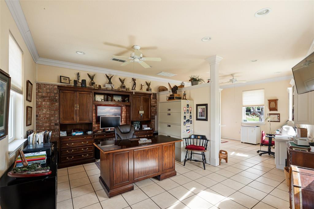 8913 Brierfield Road Granbury, TX 76049 - Photo 36 of 40 a kitchen with stainless steel appliances kitchen island granite countertop a stove and a refrigerator