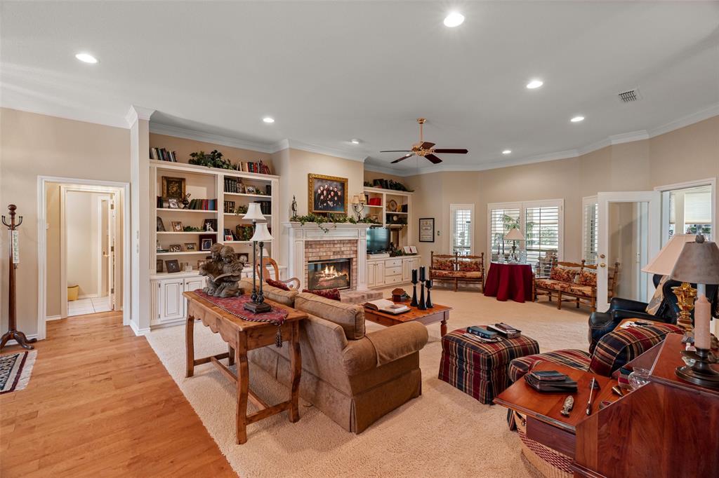 8913 Brierfield Road Granbury, TX 76049 - Photo 4 of 40 a living room with fireplace furniture and a wooden floor