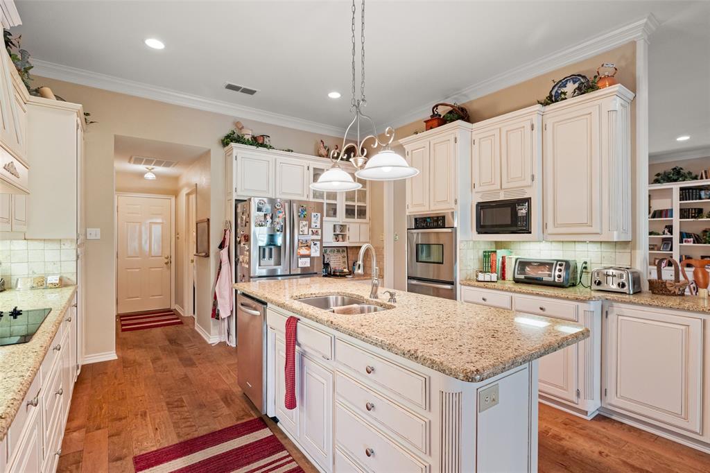 8913 Brierfield Road Granbury, TX 76049 - Photo 10 of 40 a kitchen with stainless steel appliances granite countertop a sink stove and refrigerator