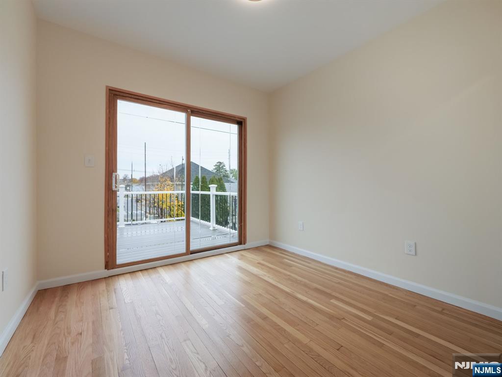 413 Lanza Avenue Garfield, NJ 07026 - Photo 15 of 37 a view of empty room with wooden floor and fan