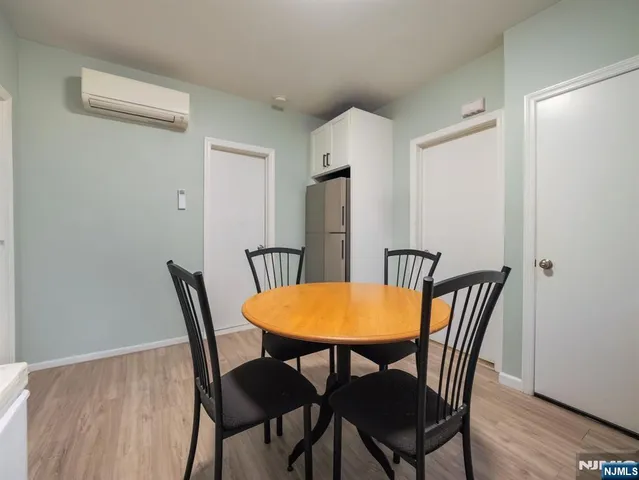 a bed sitting in a bedroom and wooden floor