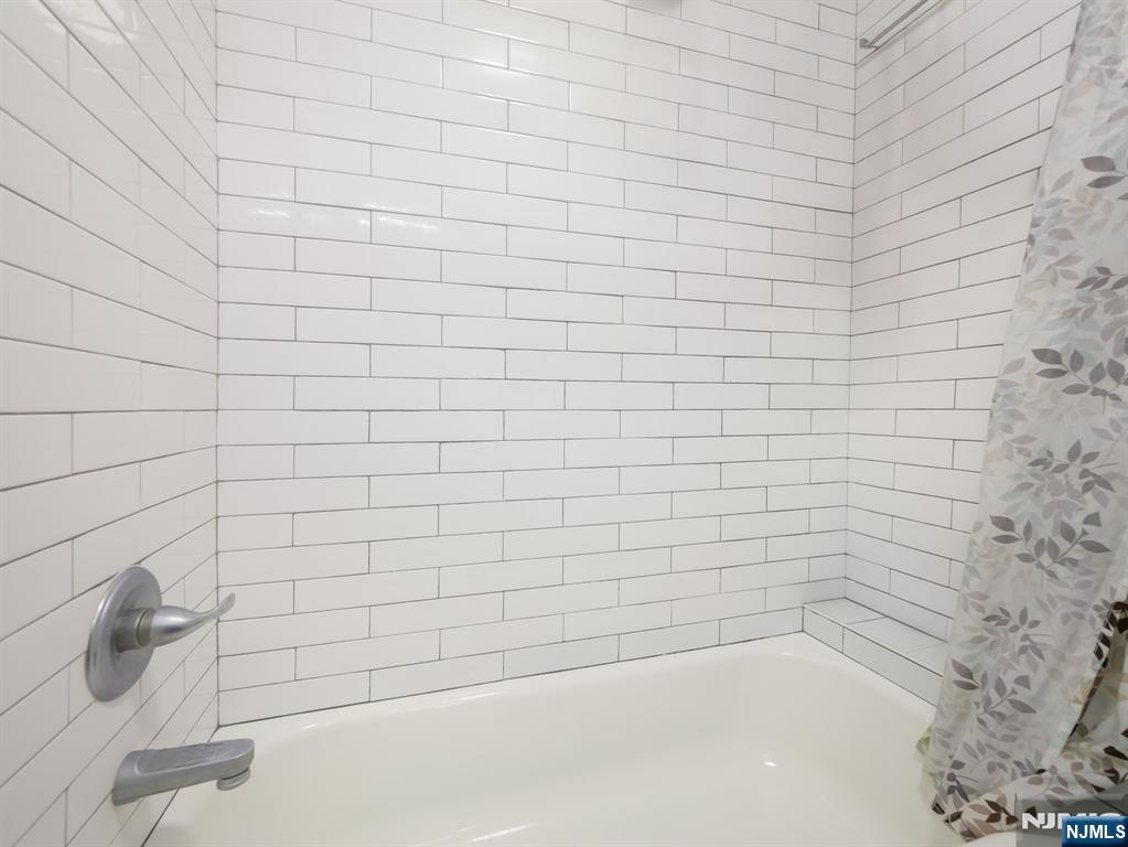413 Lanza Avenue Garfield, NJ 07026 - Photo 23 of 37 a bathroom with a white bathtub