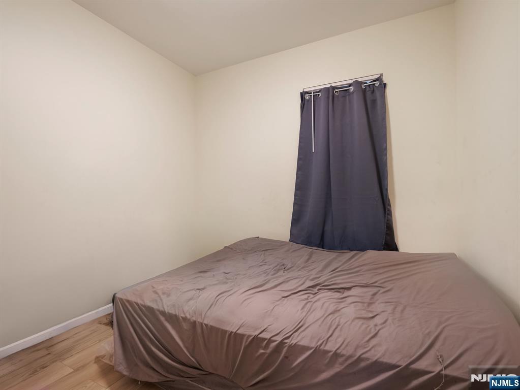 413 Lanza Avenue Garfield, NJ 07026 - Photo 25 of 37 a bed sitting in a bedroom and wooden floor