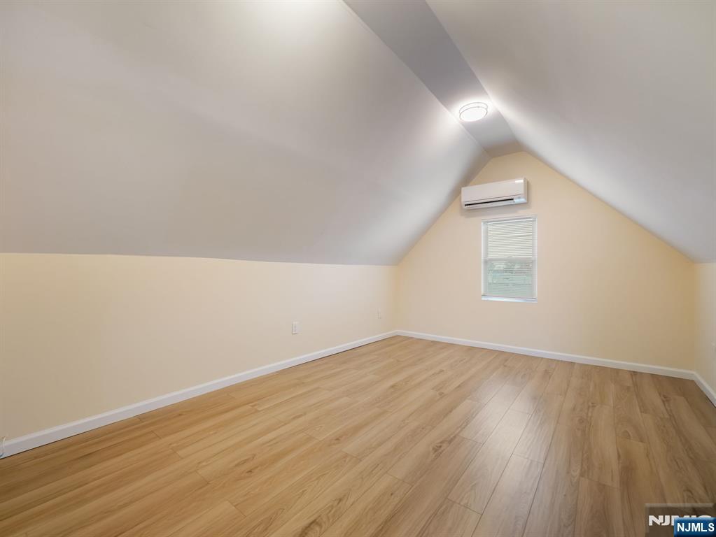 413 Lanza Avenue Garfield, NJ 07026 - Photo 4 of 37 an empty room with wooden floor and windows