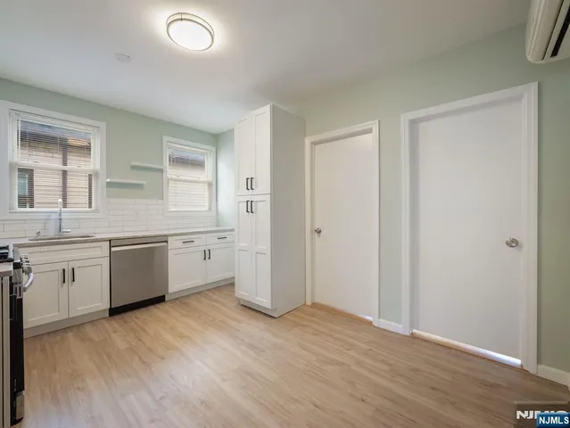 an empty room with a hardwood and a window