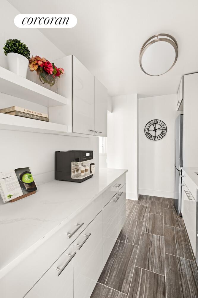 345 East 73rd Street, Unit 12D Manhattan, NY 10021 - Photo 3 of 12 a kitchen with a refrigerator and a stove