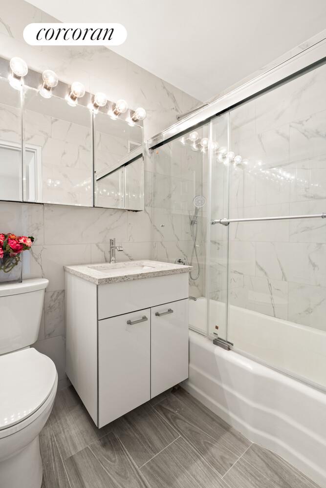 345 East 73rd Street, Unit 12D Manhattan, NY 10021 - Photo 6 of 12 a bathroom with a sink and a mirror