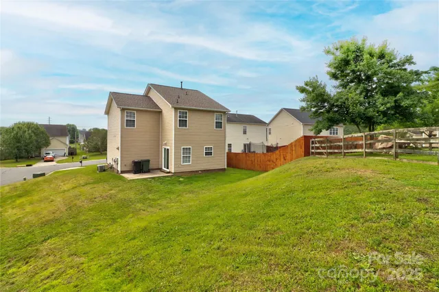 a view of a house with a yard and sitting area