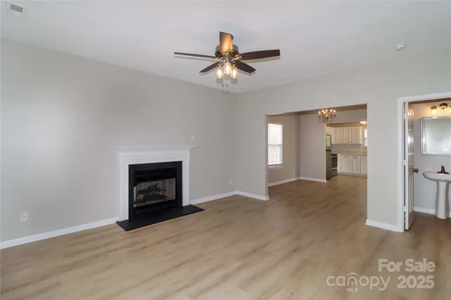 a view of empty room with a fireplace and fan