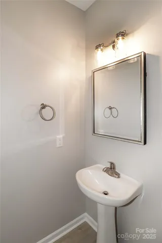 a bathroom with a sink a mirror and vanity