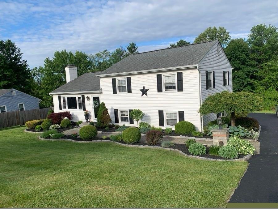 a front view of a house with a garden and porch
