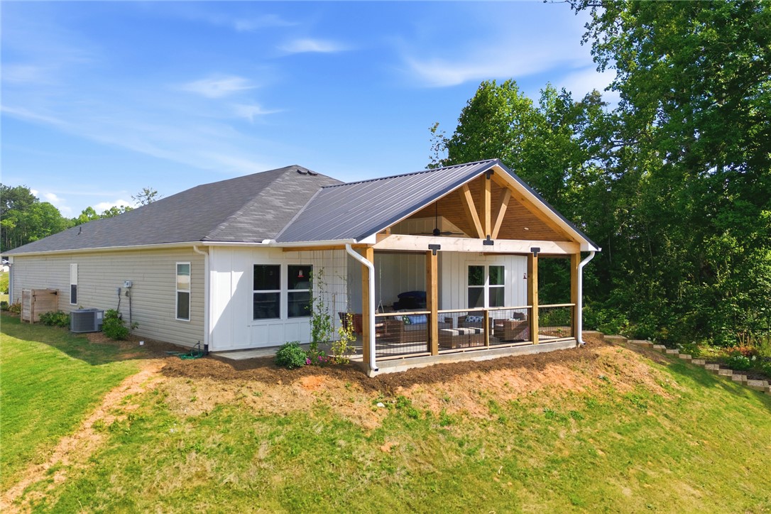 412 Chadwick Lane Walhalla, SC 29691 - Photo 23 of 37 This newly constructed home boasts a charming covered patio and a modern metal roof.