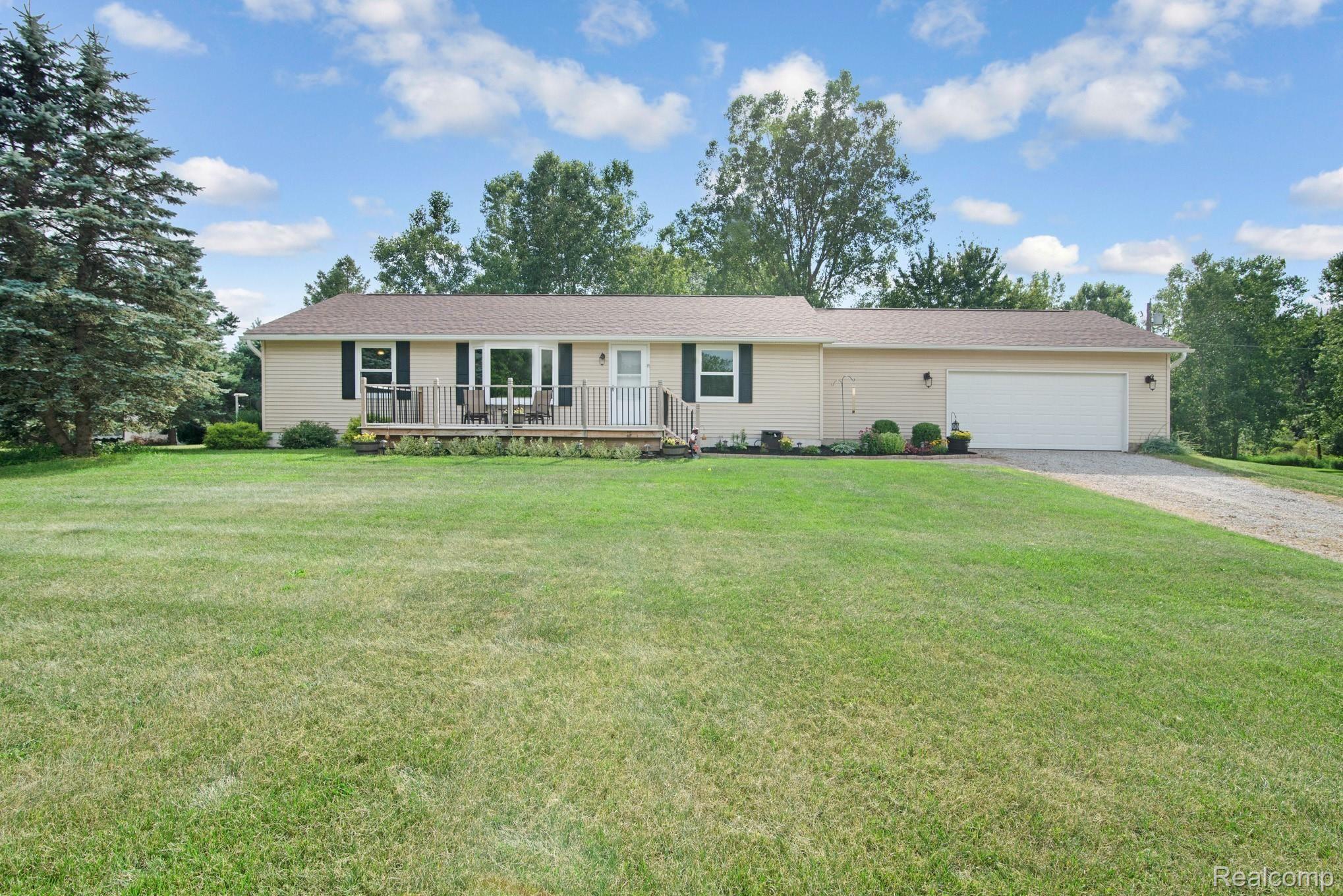 6671 North Fowlerville Road Fowlerville, MI 48836 - Photo 23 of 27 Front of home with deck