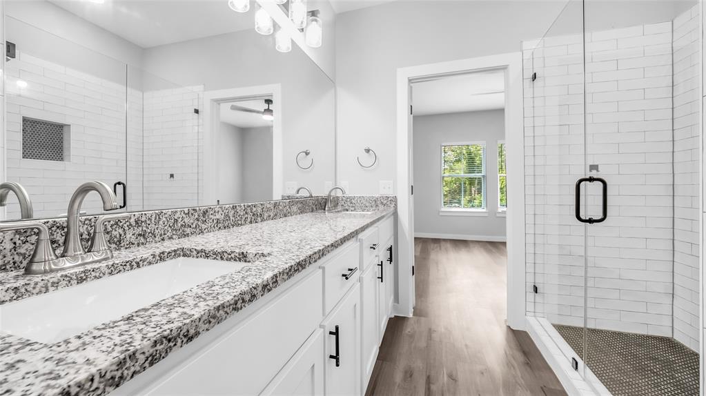 716 East Chestnut Street Denison, TX 75021 - Photo 21 of 26 Bathroom featuring a double vanity with stone countertops, undermount sinks, and brushed nickel faucets