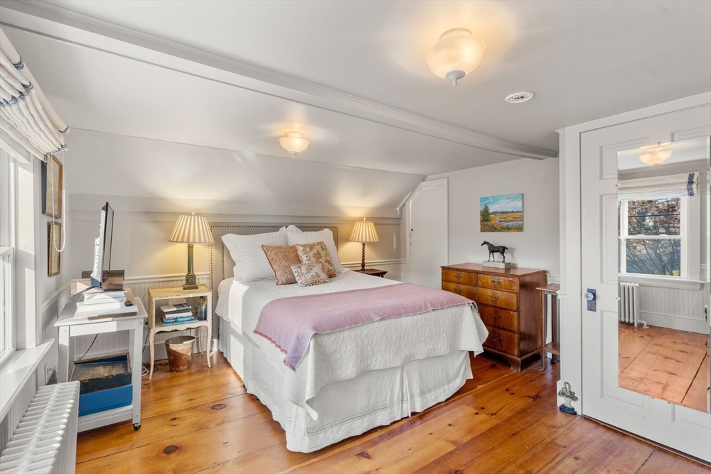 20 Haskell Street Gloucester, MA 01930 - Photo 11 of 27 a spacious bedroom with a bed and wooden floor