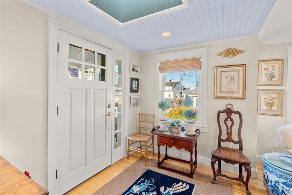 20 Haskell Street Gloucester, MA 01930 - Photo 15 of 27 a living room with furniture a dining table and paintings on the wall