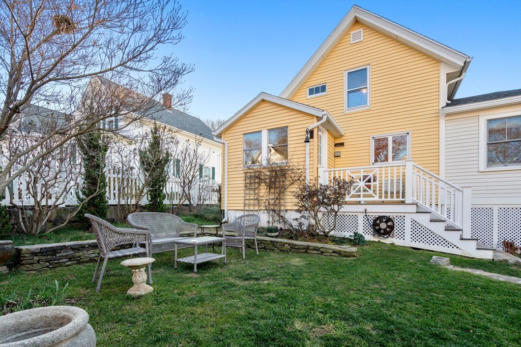 20 Haskell Street Gloucester, MA 01930 - Photo 20 of 27 a backyard of a house with table and chairs