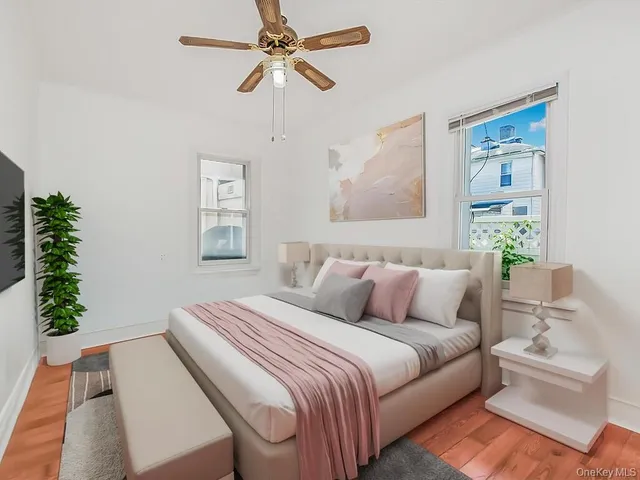 a bedroom with a large bed and a chandelier