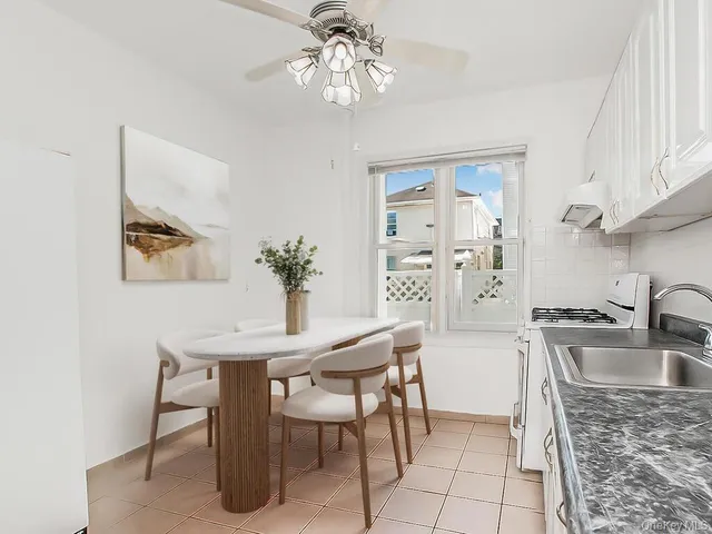 a view of a dining room with furniture and chandelier