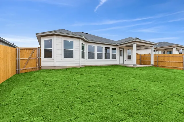 a front view of a house with a garden and yard