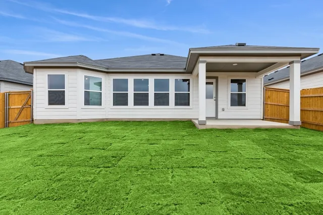 a view of a house with a backyard