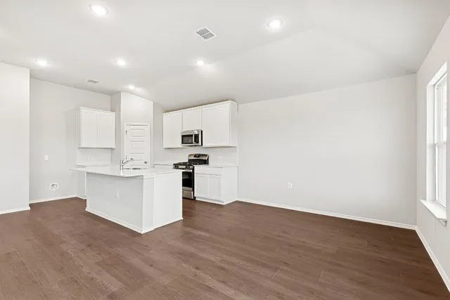 a kitchen with white cabinets and white appliances
