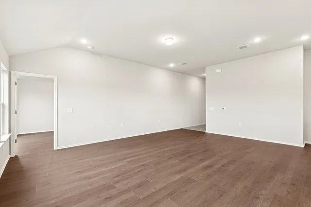an empty room with wooden floor