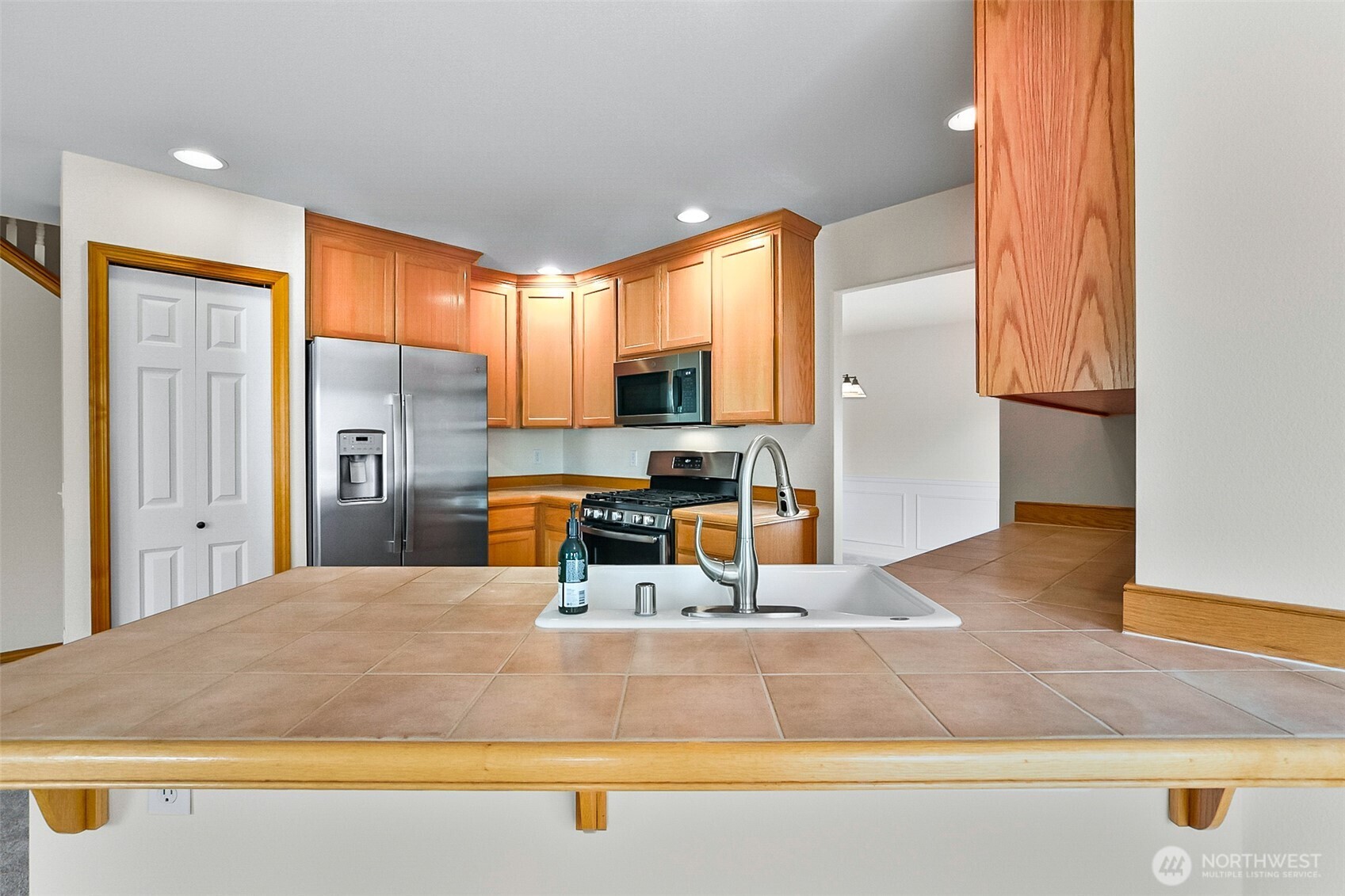 18410 11th Drive Southeast Bothell, WA 98012 - Photo 12 of 40 a kitchen with stainless steel appliances granite countertop a refrigerator and a sink